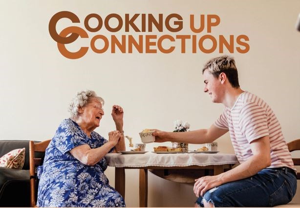 Older female and younger person enjoying a meal